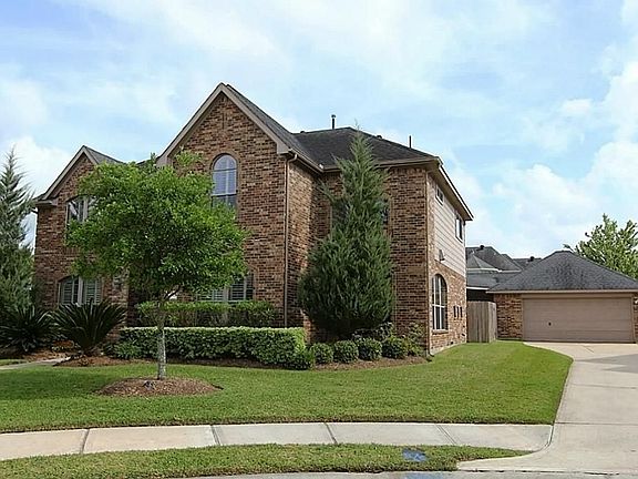 The spacious driveway leads to the detached and oversized two car garage with workshop.