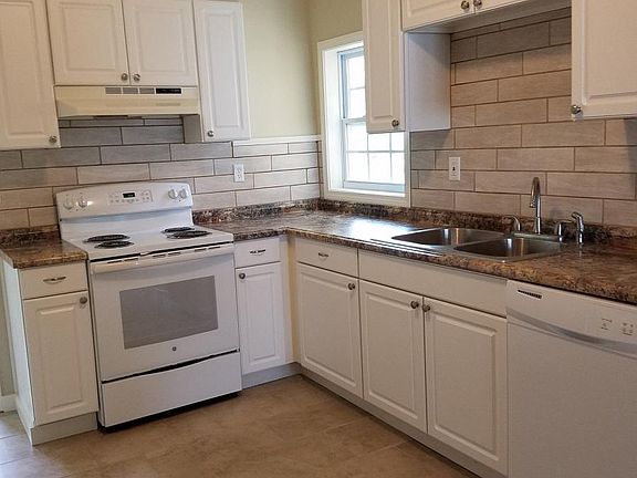 Brand new kitchen with electric stove and dishwasher