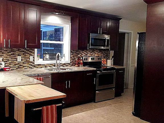 Updated kitchen w/ new wood cabinets, granite counters, new SS appliances and more.