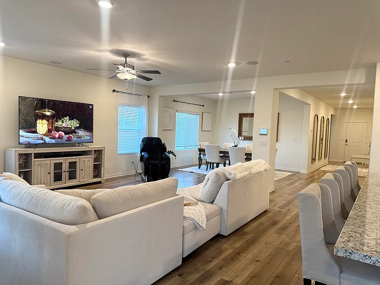 Open living space with defined areas for tv, kitchen, dining and working