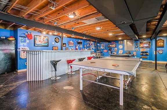 Corrugated bar with concrete top, stained concrete floor make for easy clean up after your family ga