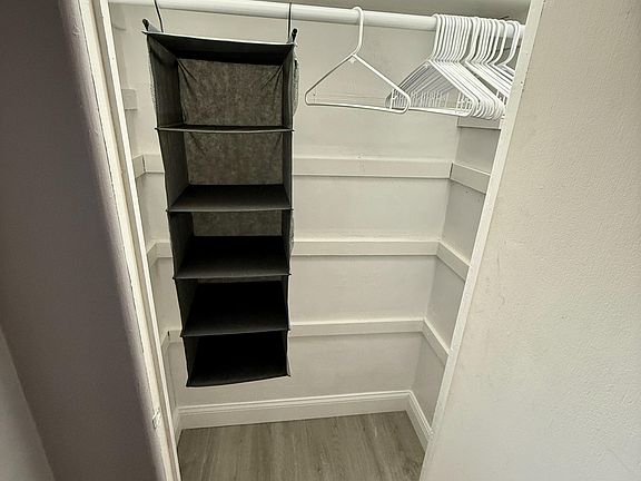 Full closet with plenty of story across hall from door to room