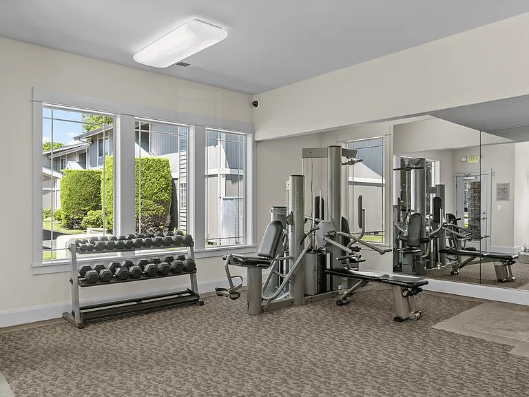 On-site fitness center with strength equipment and free weights.