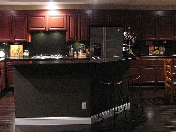 Evening shot: Beautiful cranberry colored cabinets, black granite counters