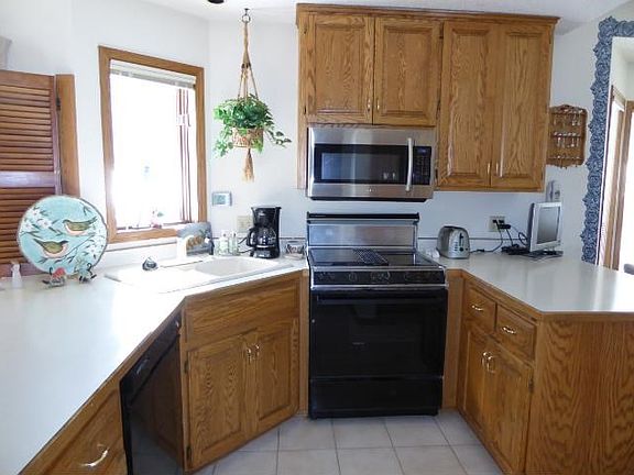 A PERFECT BALANCE of style & function. Beautiful sun filled kitchen with plenty of cupboards & counter space open to both dining areas with kitchen "pass thru"