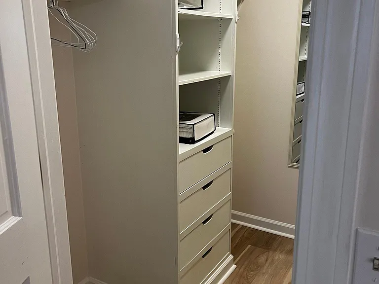 Large walk-in closet with built-in chest of drawers