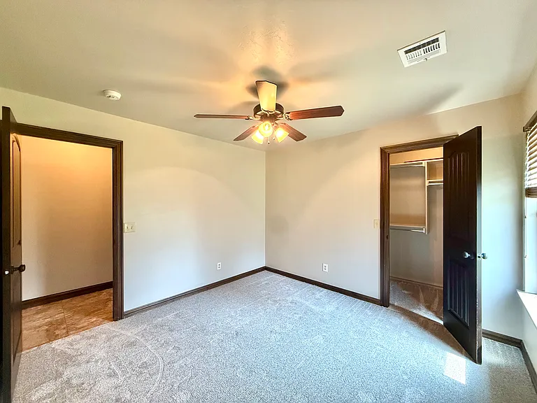 After the linen closet is the third bedroom. This bedroom has a very large closet with built-in shelving. Large window for natural light. New paint and new carpet make this room glow!