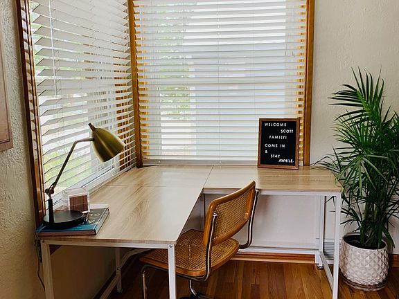 The corner desk in the front entrance offers ample space for organization and work.
