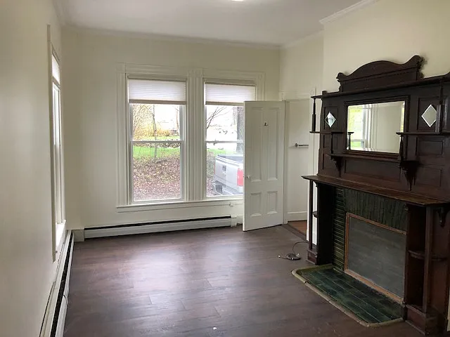 Living Room with original fireplace mantel. Very Bright & Sunny