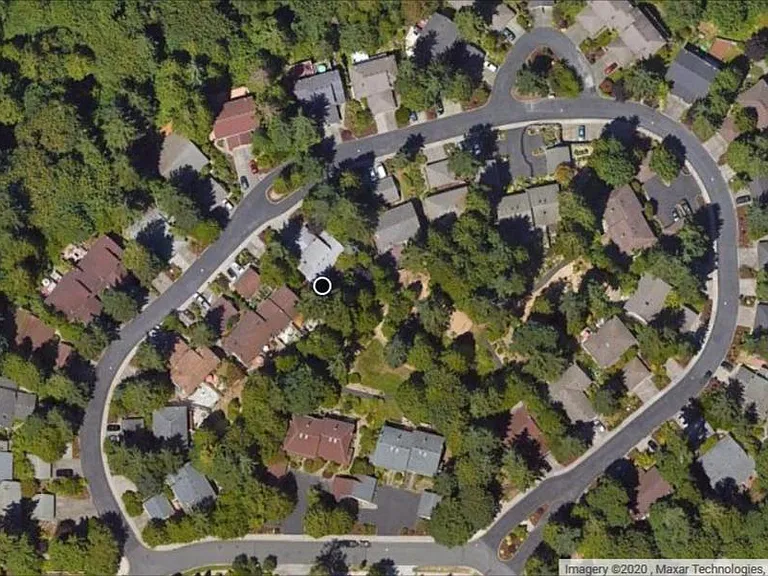 Quiet, circular loop subdivision of 92 homes bordered by sidewalks and featuring wooded common area of trails and lawn in the center.