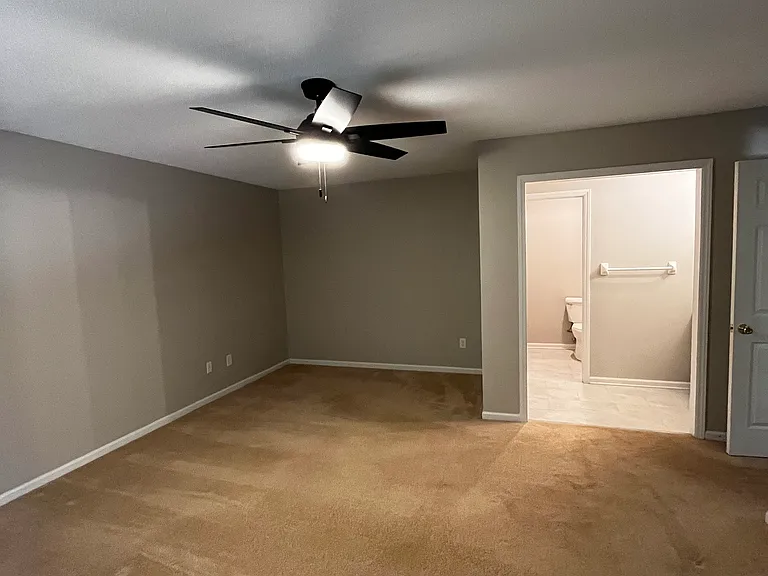 master bedroom with an en suite full bathroom