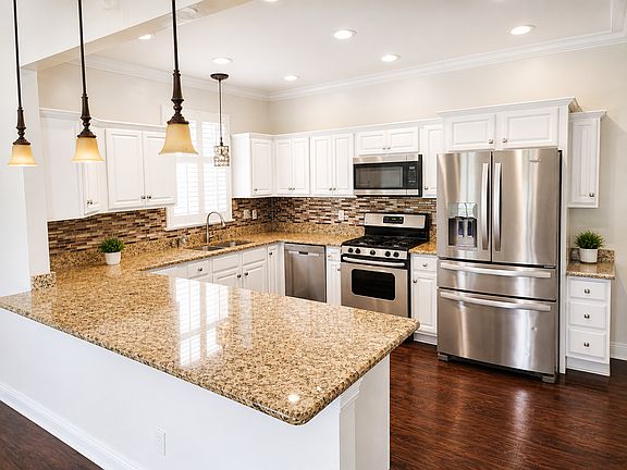 Kitchen with granite countertops and gas stove.