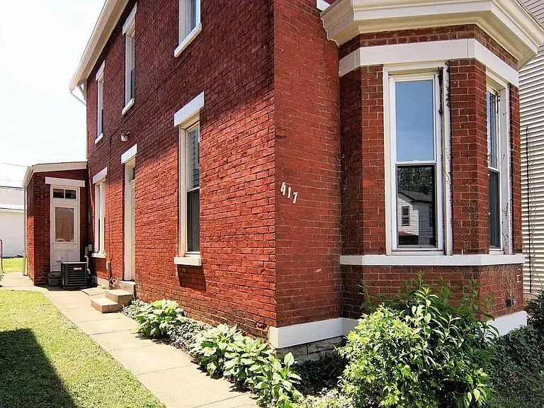 The nicely landscaped side entrance.