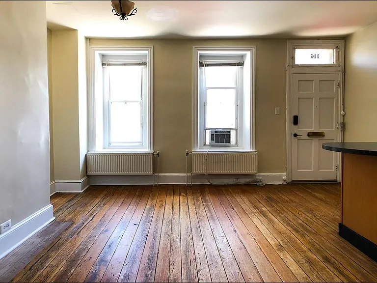 The living room has been refreshed with refinished hardwood floors, recessed lighting, and new windows to fill the space with natural light. Updated listing photos coming soon!