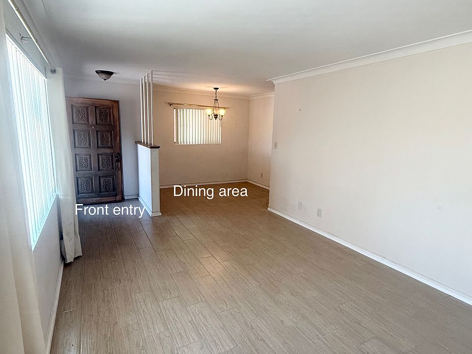 Living area showing dining area and front entry