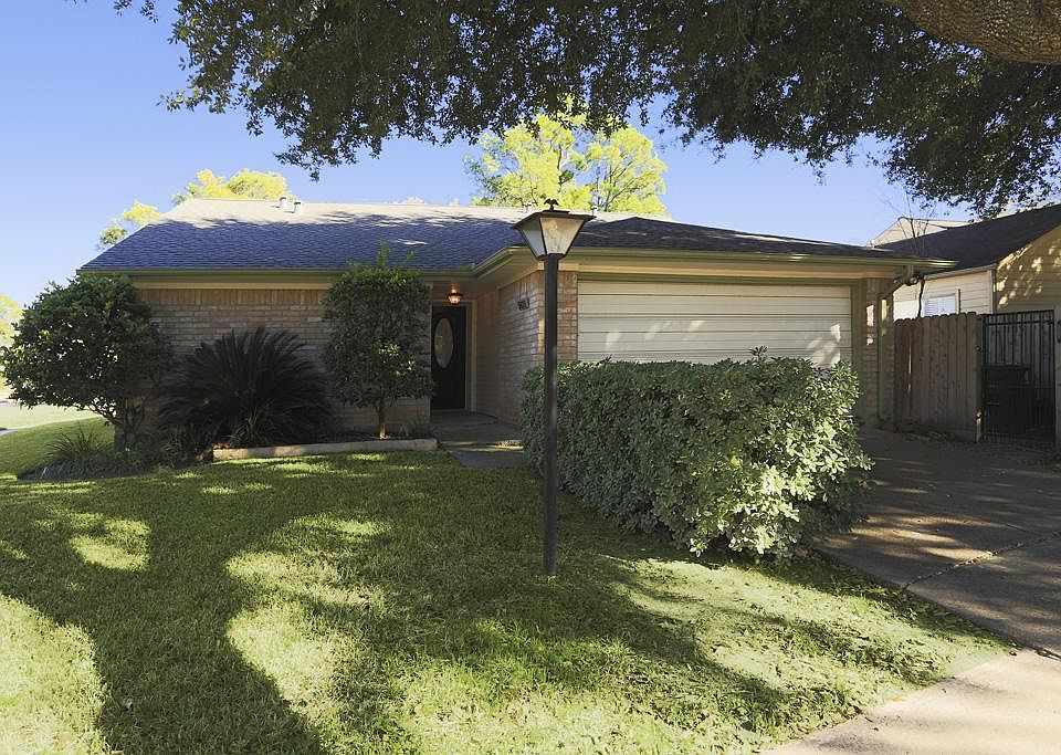 FRONT OF HOME - View from street. Enjoy walking up to your stunning little corner gem! Well maintained yard with beautiful landscaping! Spacious 2 car garage with additional driveway and street parking. Gate to right leads to your private patio area.