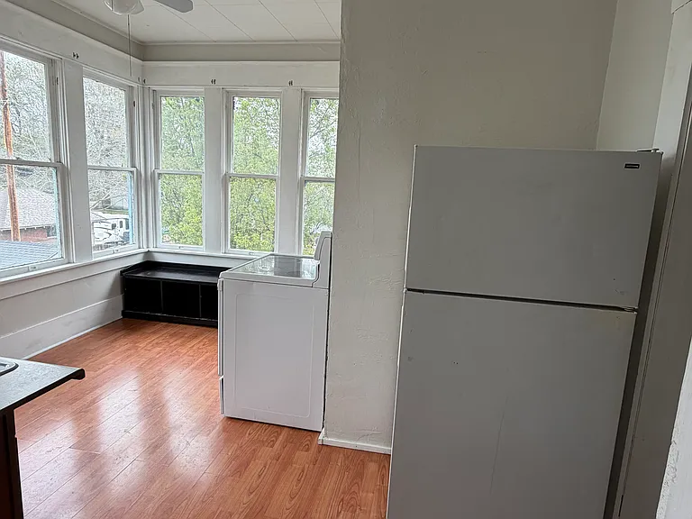 Kitchen has a flat top stove, full size refrigerator and under cabinet refrigerator, and large pantry room