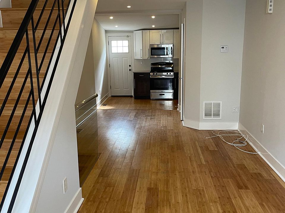 living room, bathroom on right, kitchen, back door to patio, basement stairs beneath stairs to second floor