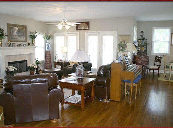 Sunny and open family room with french doors leading to wrap around porch...