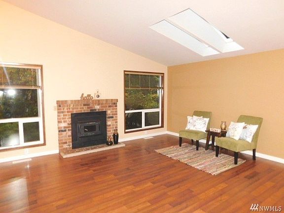 Large windows in front of home with wood fireplace .