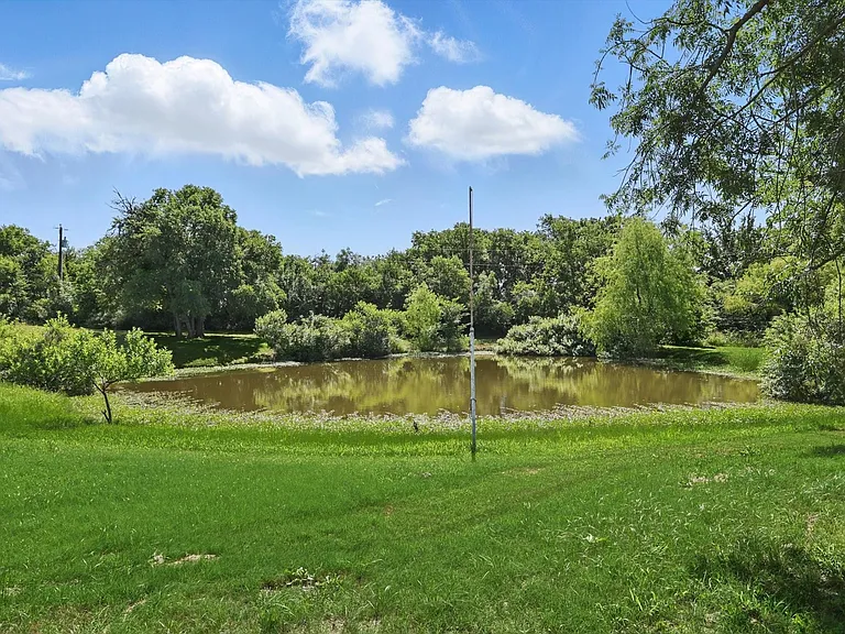 View of green lawn featuring a water view