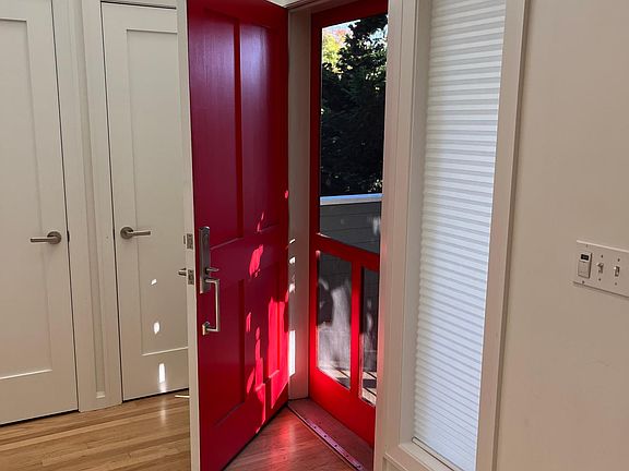 Main door. A small deck is outside with two flights of stairs leading up to it.