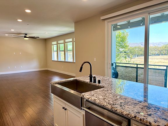 Eastern-facing living space with open floor plan for living room, dining, and kitchen