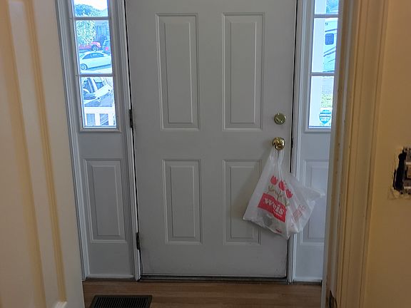 Inside the front door looking out from the 1/2 bath