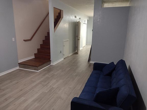 Living room leading to the stairs, dining area, downstairs bathroom, kitchen, pantry, and washer and dryer area.