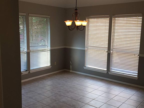 Formal dining room is adjacent to the front foyer. Plantation shutters are on windows throughout the home.
