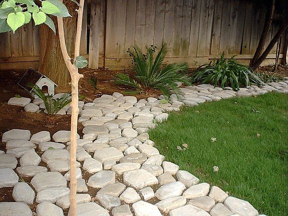 Newly paved back yard, with stone, with new winter grass 