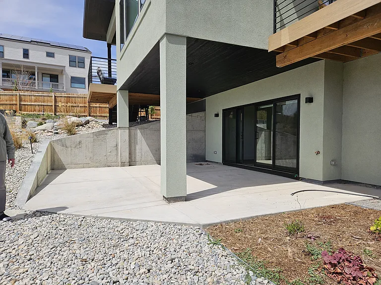 East-side view of the South-side entry into the lower-level rental rooms, if having walked around the East-side from the North-side driveway.