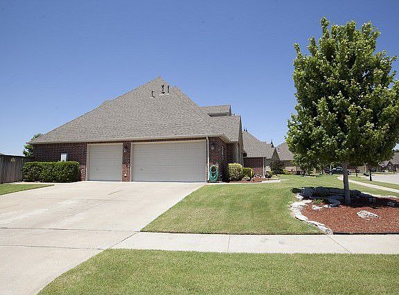Coveted side-load 3-car garage withwork room