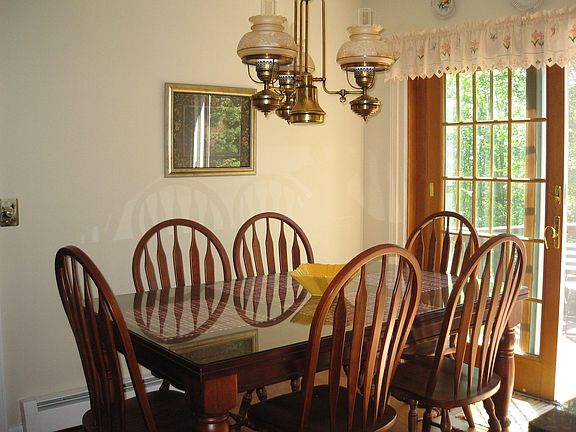eating area in kitchen with sliding french doors to wraparound deck