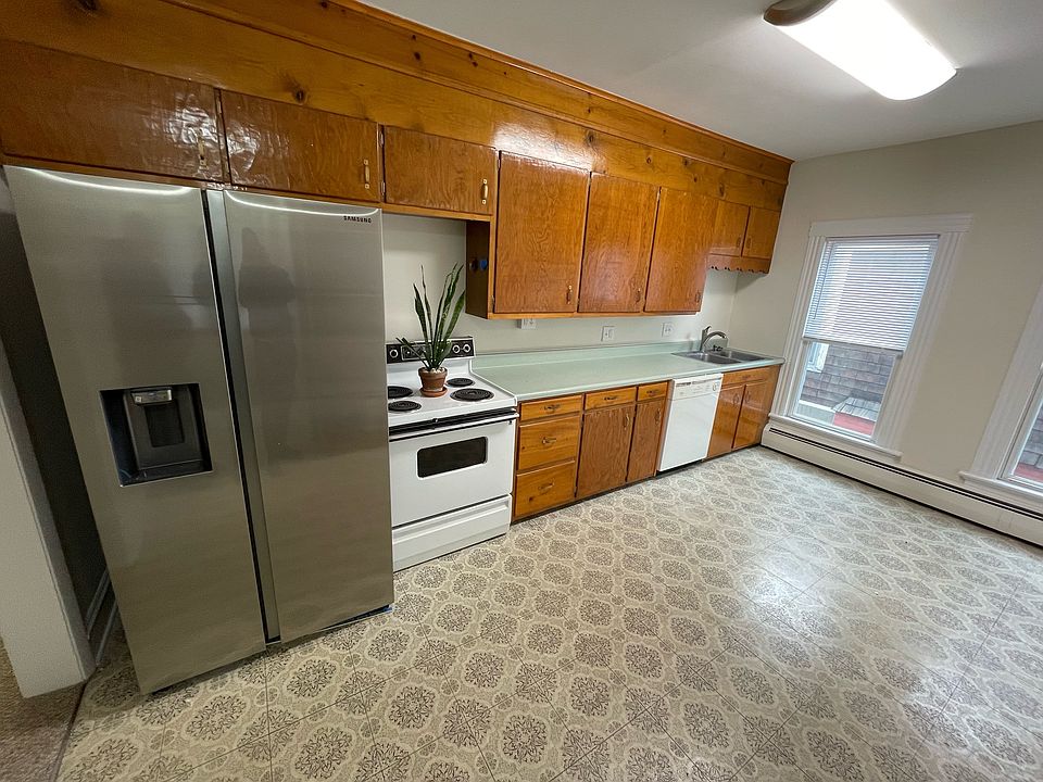 Kitchen with new stainless refrigerator.