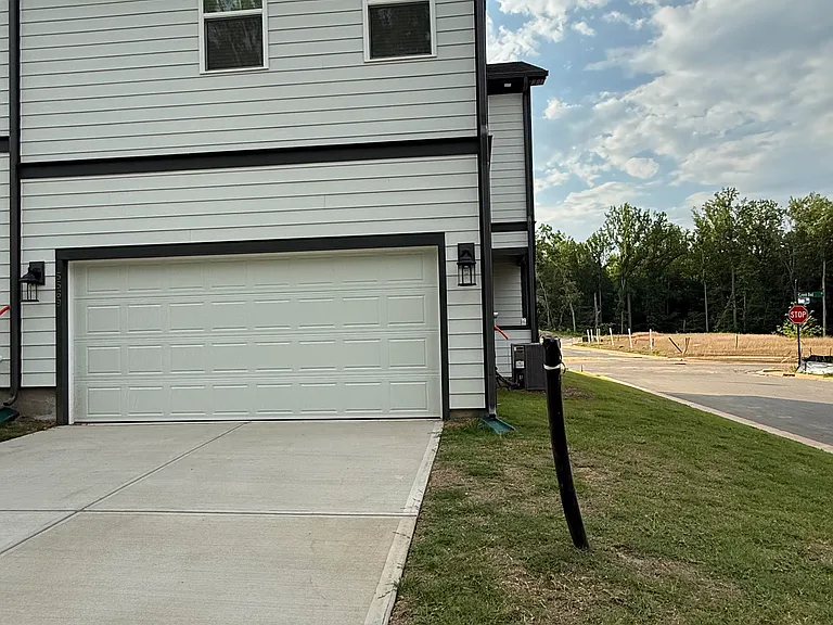 Attached two-car garage with private driveway parking.