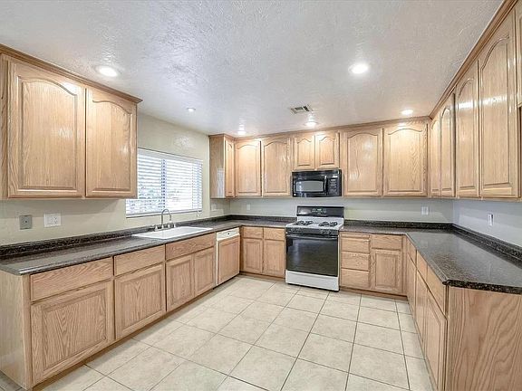 Modern Kitchen with new dishwasher, stove, and microwave.