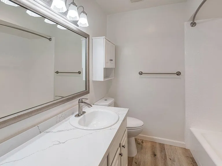 Apartments in West Los Angeles, CA Del Rio bathroom with storage and curved shower rod