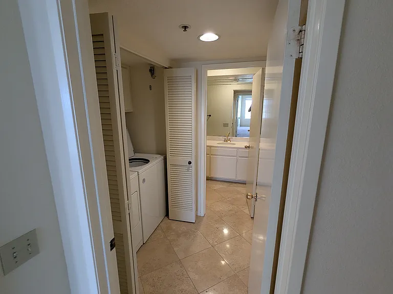 Laundry area leading to bathroom