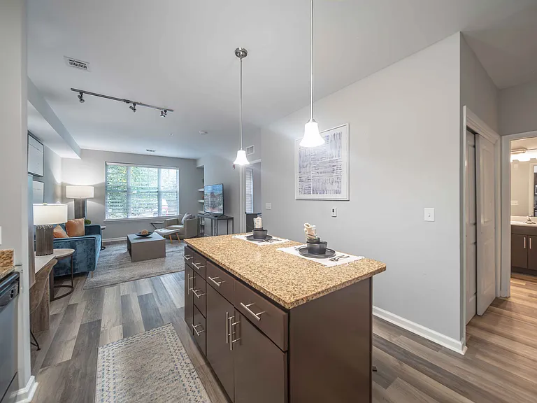 a kitchen with wooden cabinets and granite countertops at Harbor Pointe in Bayonne, NJ