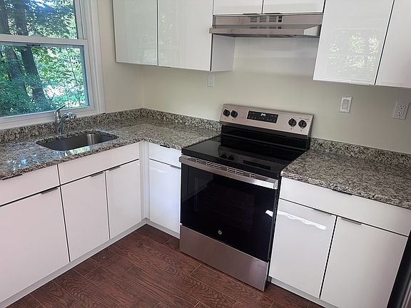 New European kitchen cabinets with new granite counter top and new GE stove.