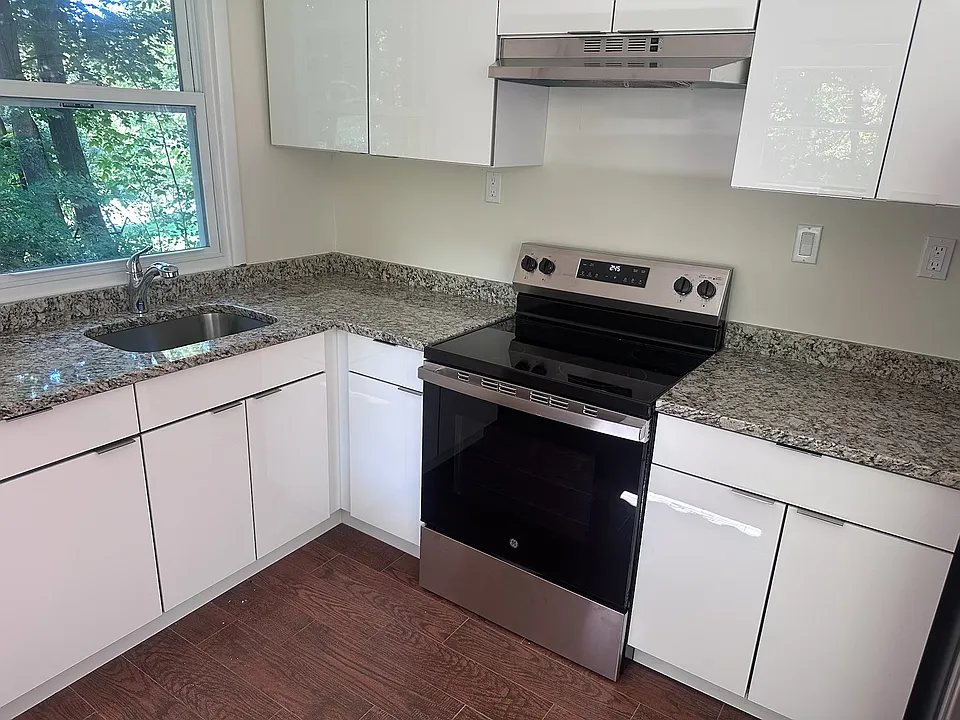New European kitchen cabinets with new granite counter top and new GE stove.