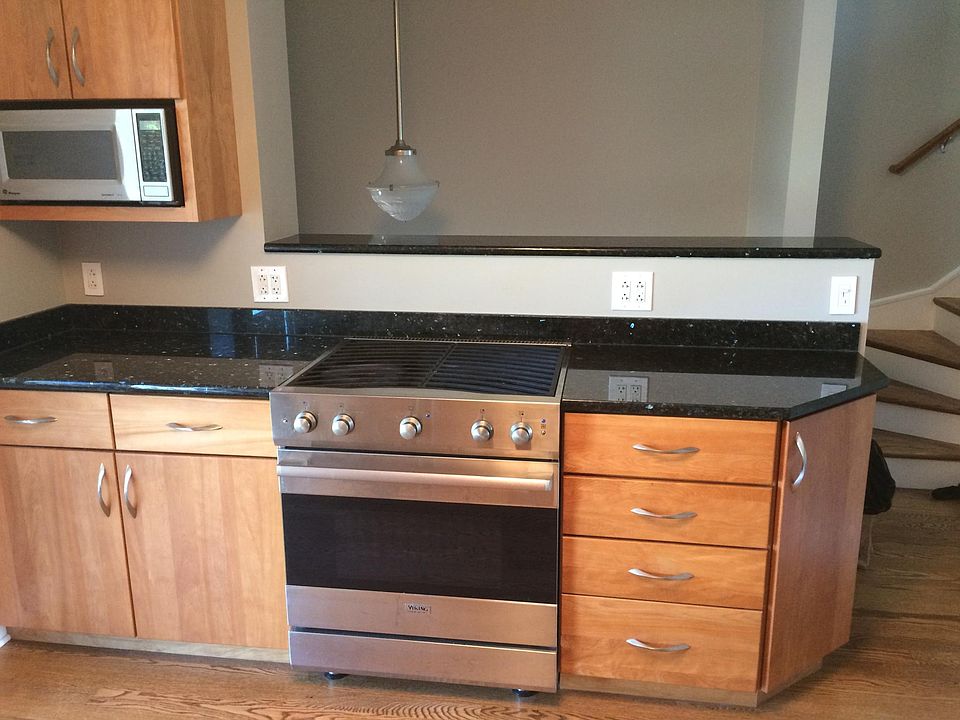 Viking gas range and kitchen opened to the stairwell. 