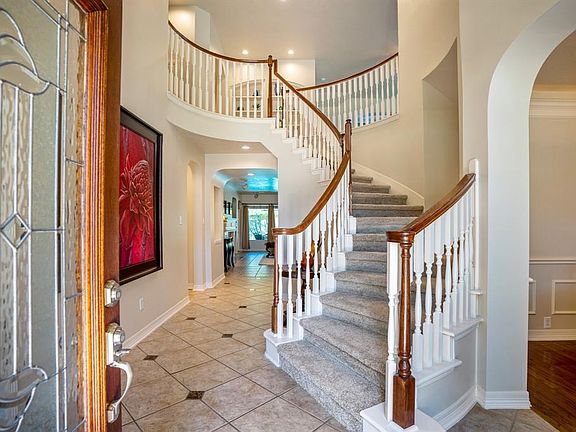 Beautiful glass lead and wood surrounding from door leads into your new home with spiral staircase leading upstairs.
