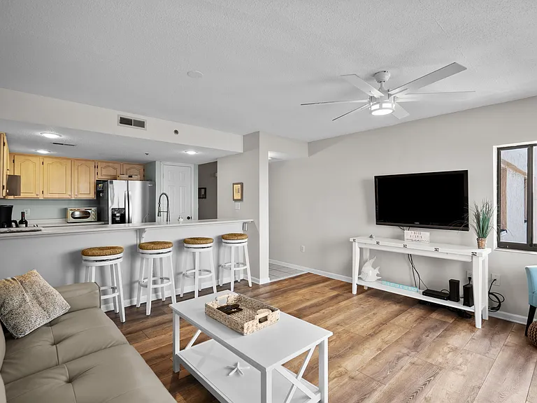 Living/dining/kitchen area as viewed from corner balcony window.
