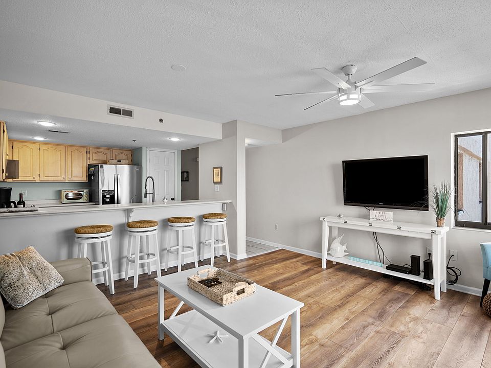 Living/dining/kitchen area as viewed from corner balcony window.