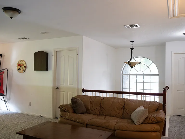 Loft facing front door, vaulted ceiling at entrance. Makes the house feel large and open.