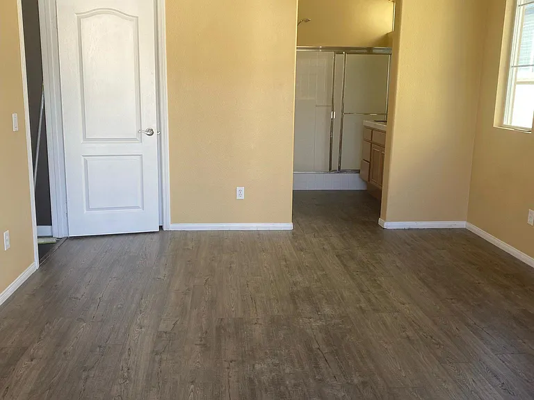 Primary bedroom with new floors and in suite bathroom