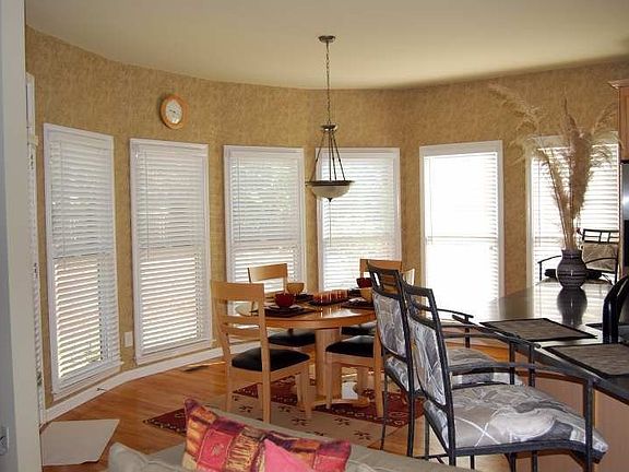 Breakfast Rooms with Wall of Windows overlooks Backyard