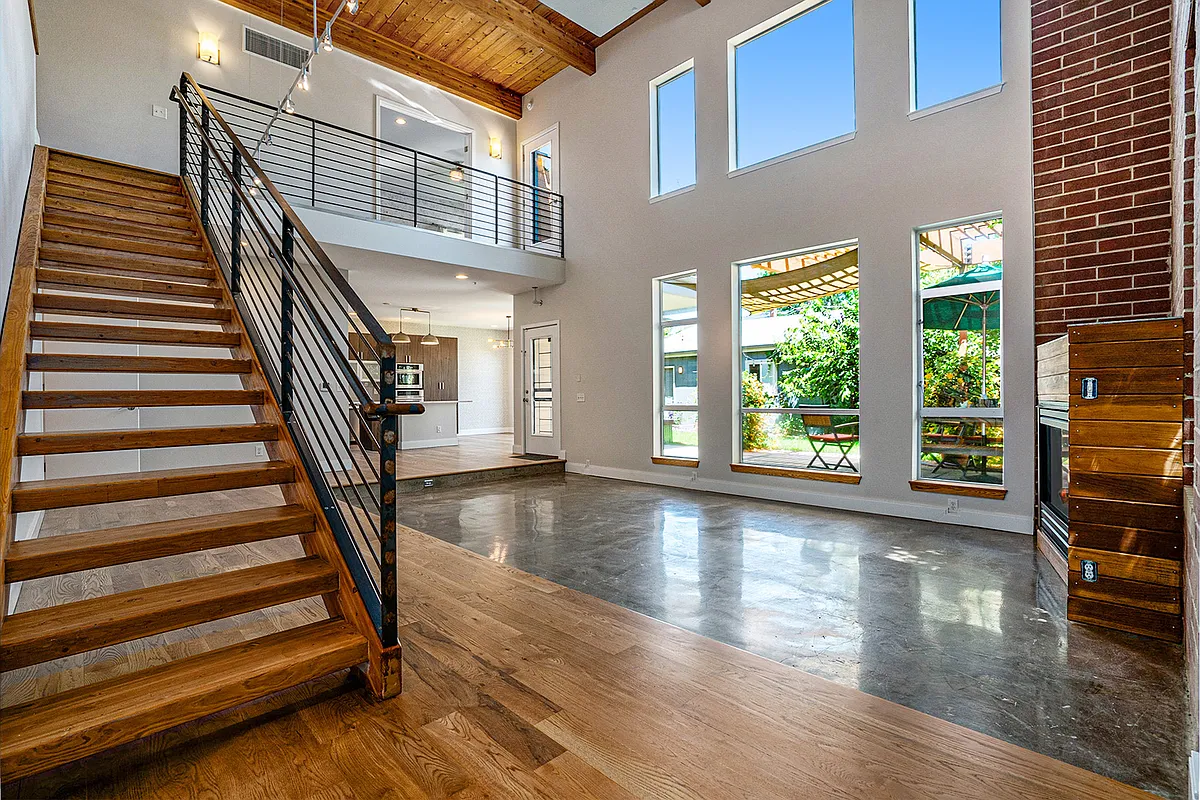 Main living space features vaulted ceilings and ample natural light. - 4258 Tennyson St #101